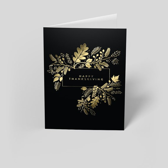 black card with gold foil botanical design and text area