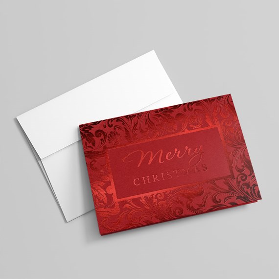 ornate red card with merry christmas text and white envelope