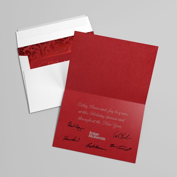 red greeting card with holiday message and signatures