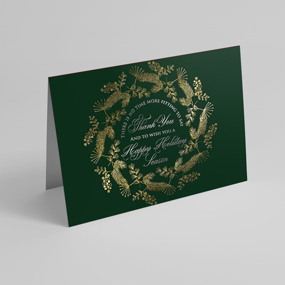 dark green card with gold wreath design and holiday text