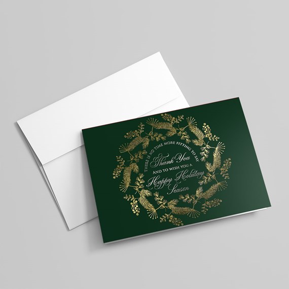 holiday card with gold wreath design and text