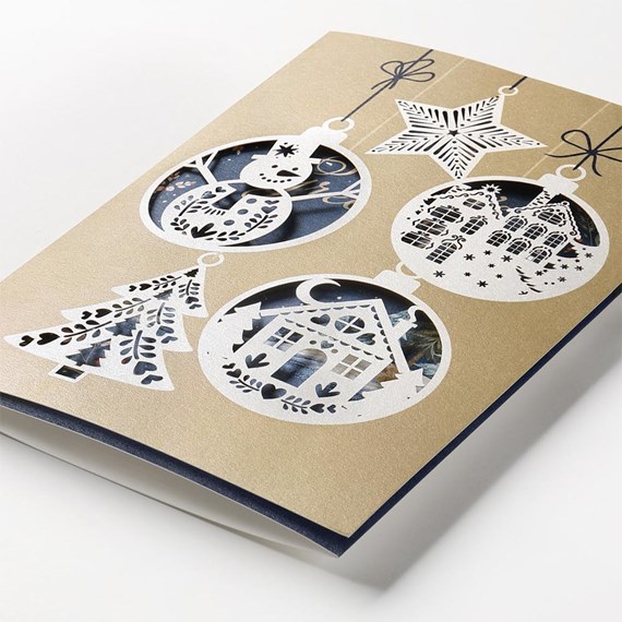 ornament cut-out card design with snowman, tree, house, and star
