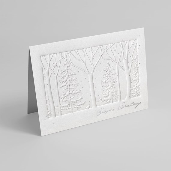textured greeting card with embossed trees and snowflakes