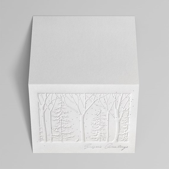 embossed winter forest card with season's greetings caption in silver foil