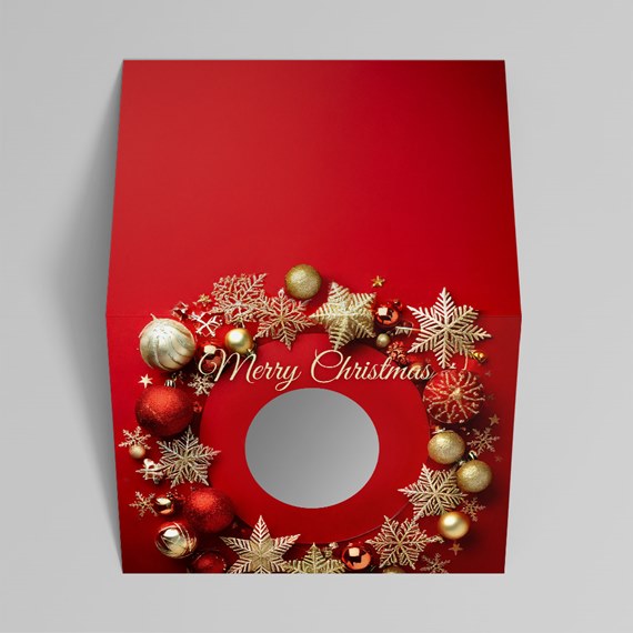 folded holiday card with a circular logo die cut