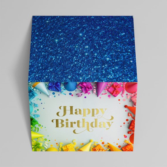 colorful birthday gift box with glitter top and party decorations