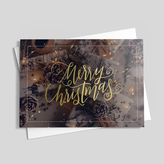 Merry Christmas card with gold foil text and festive decorations and gifts