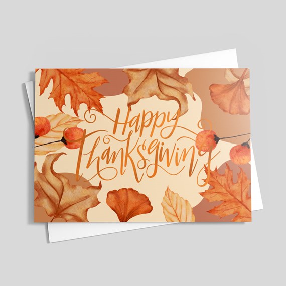 autumn leaves and berries with happy thanksgiving text