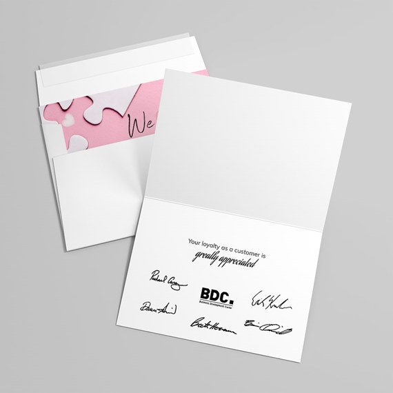 folded card with pink interior and puzzle piece design