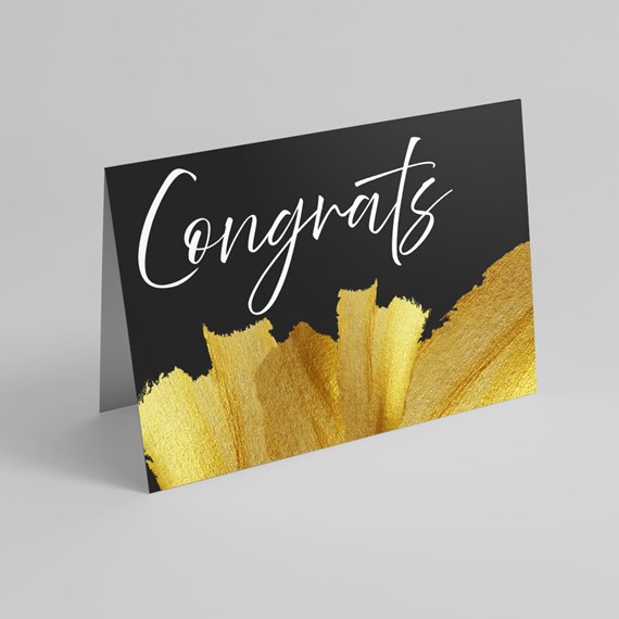 black greeting card with gold brushstroke and white text