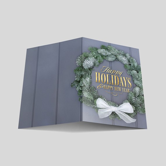 festive card with wreath and holiday greeting