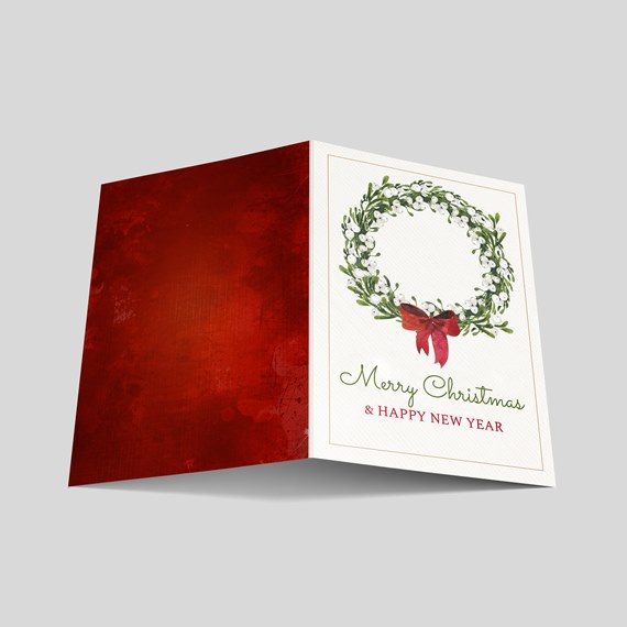 holiday card with wreath and text