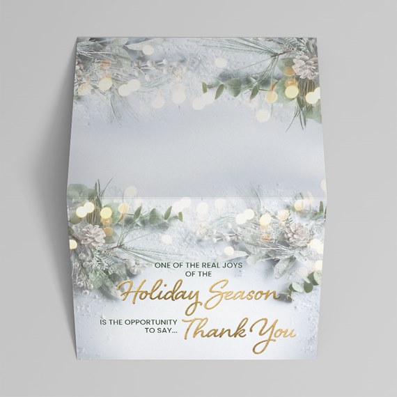 holiday thank you card design with winter foliage and gold text