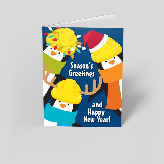 festive penguins with hard hats and scarves, greeting card, photo area