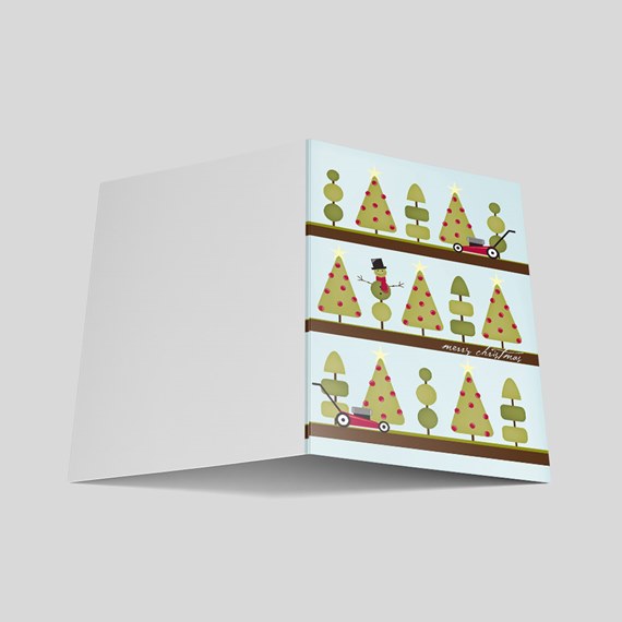 whimsical christmas card design with trees and snowman