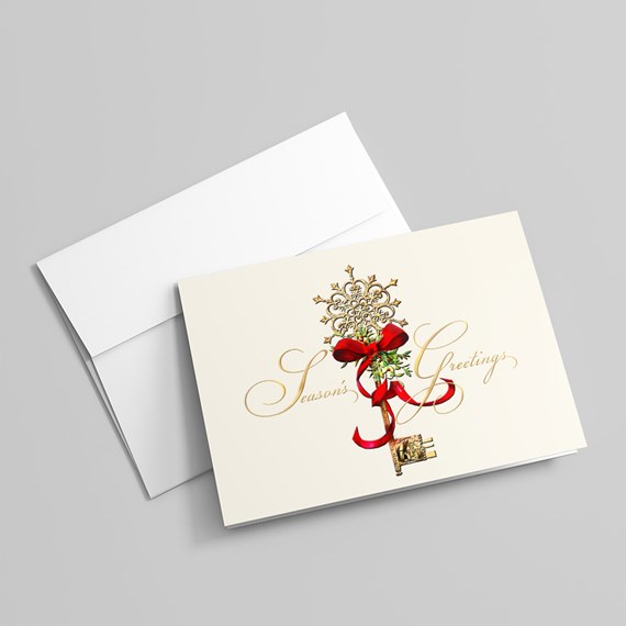cream greeting card with decorative key and ribbon