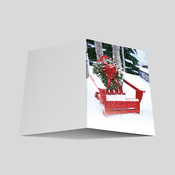 red bench with wreath in snow photo area