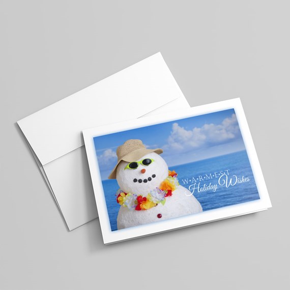 snowman with floral lei and hat, ocean background, holiday card